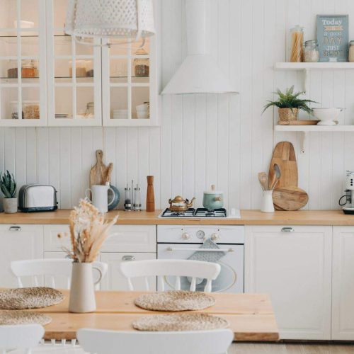 Scandinavian kitchen design. Modern dining room decoration. White luxurious interior and appliance.